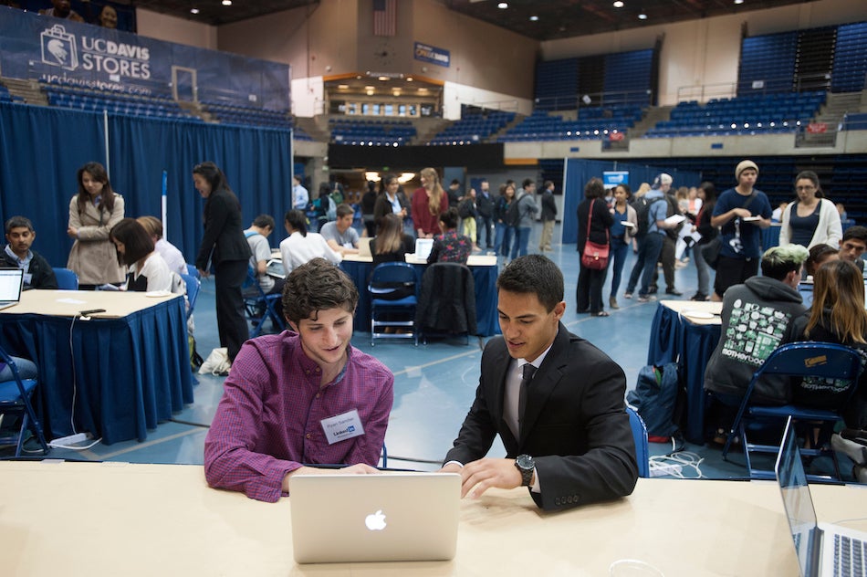 A student talks with an advisor in a conference. 