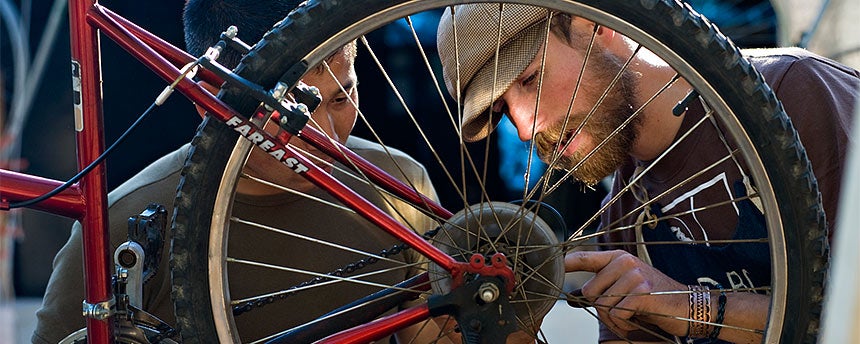 Two men fixing a bike