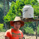 farmer in Guatemala next to irrigation tank