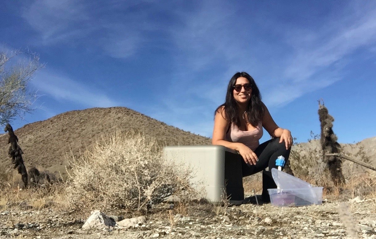 Female scientist samples soils