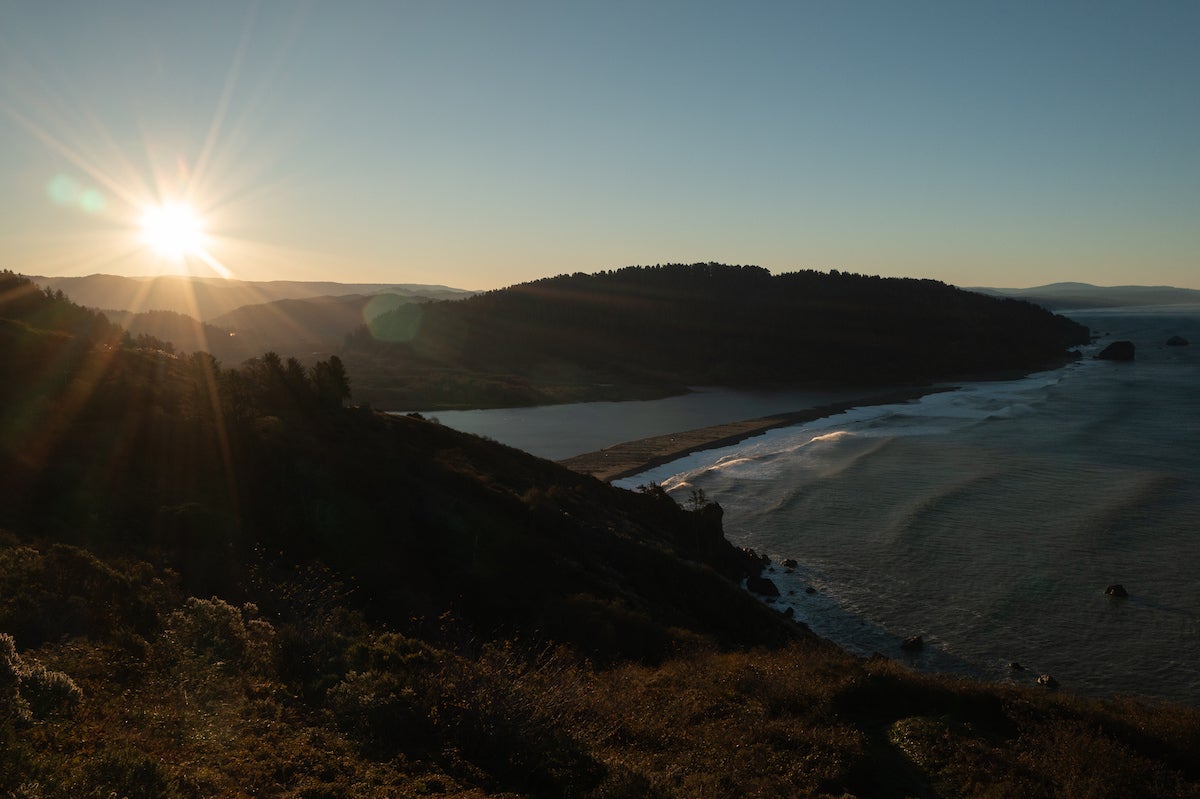 Aerial shot of sunrise over the Pacific Ocean and mouth of the Klamath iver