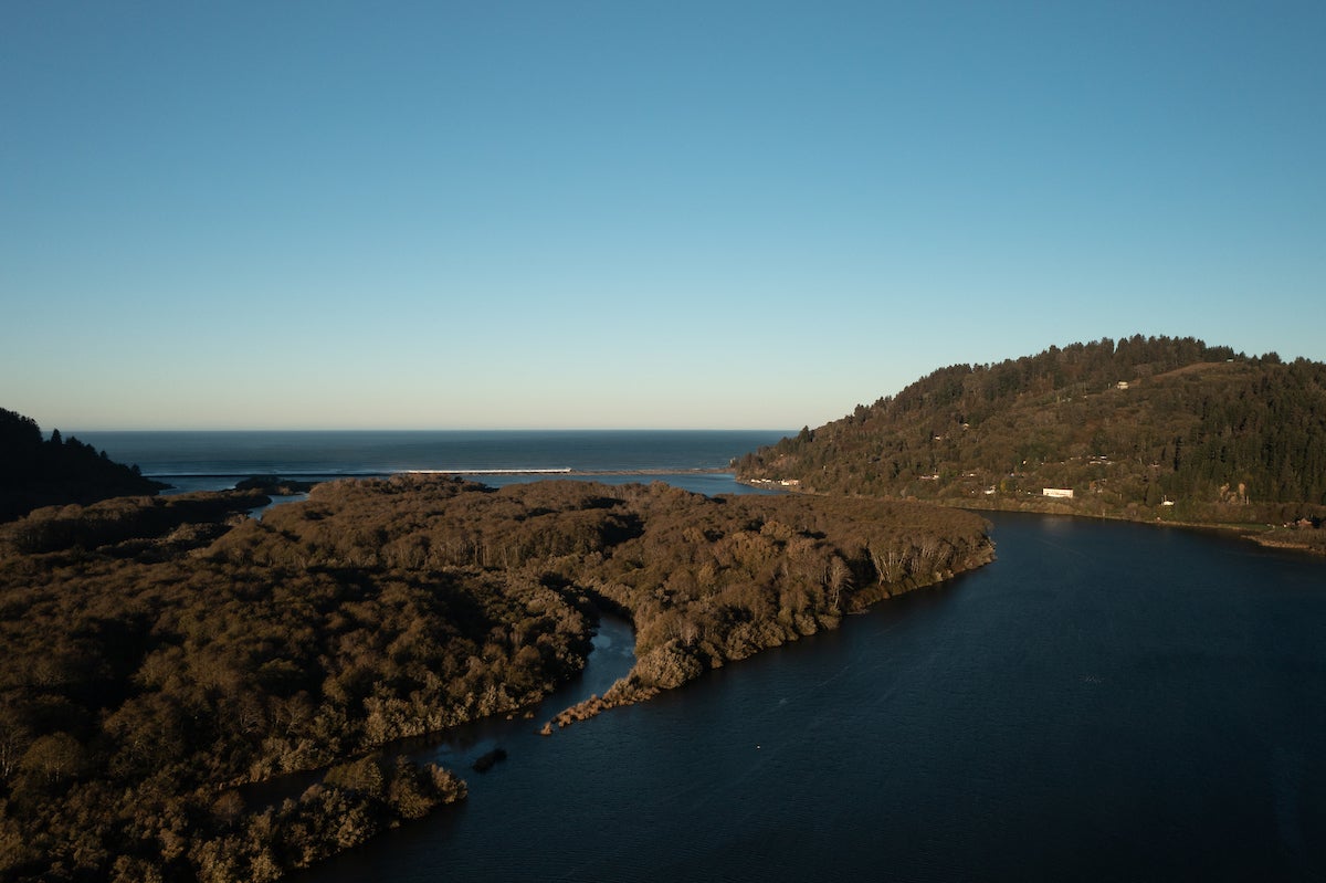 Aerial photo of the Klamath River curving and emptying into the Pacific Ocean