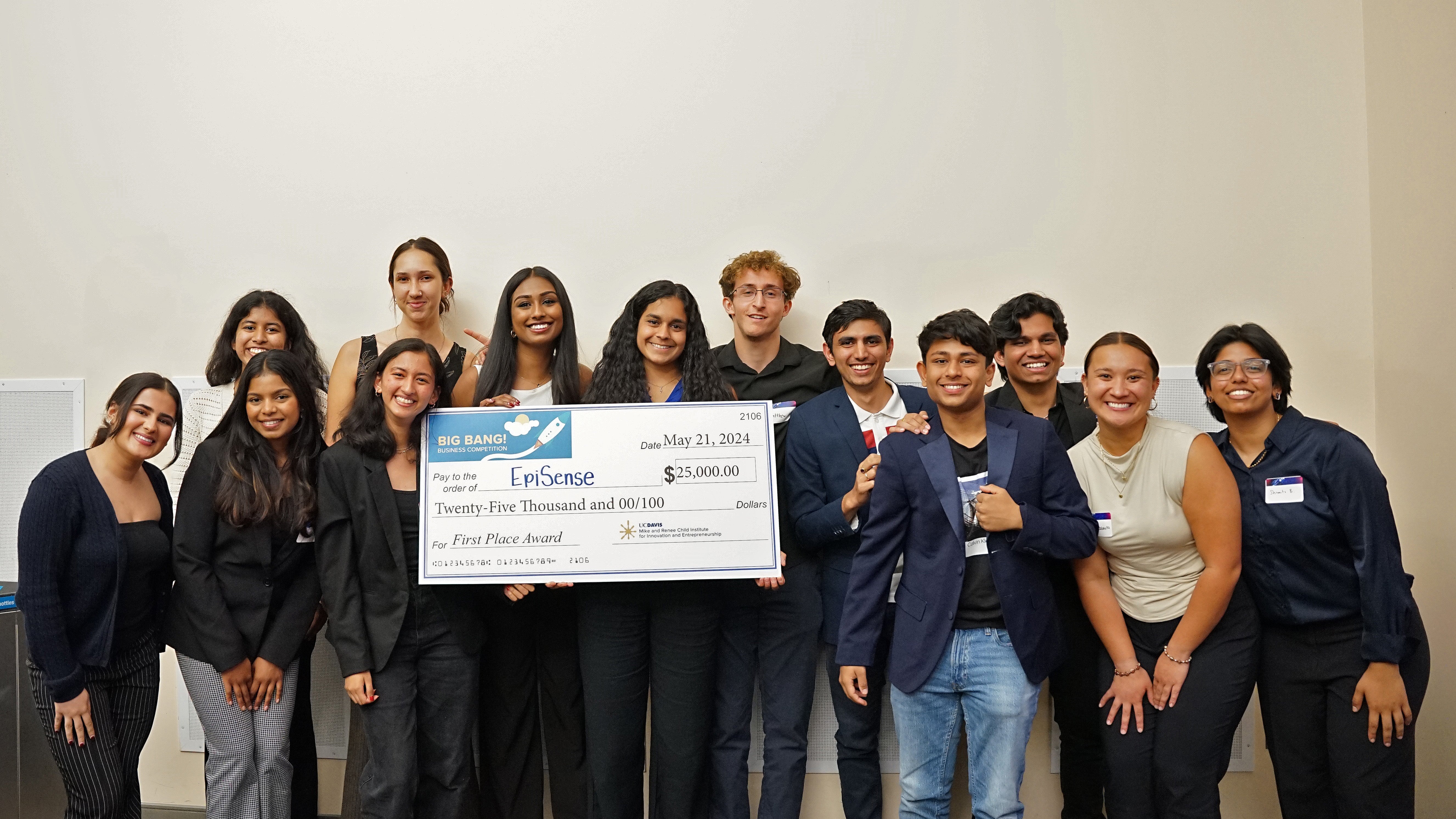 Students who were finalists in Big Bang! stand in a photo together holding an artifical large check.
