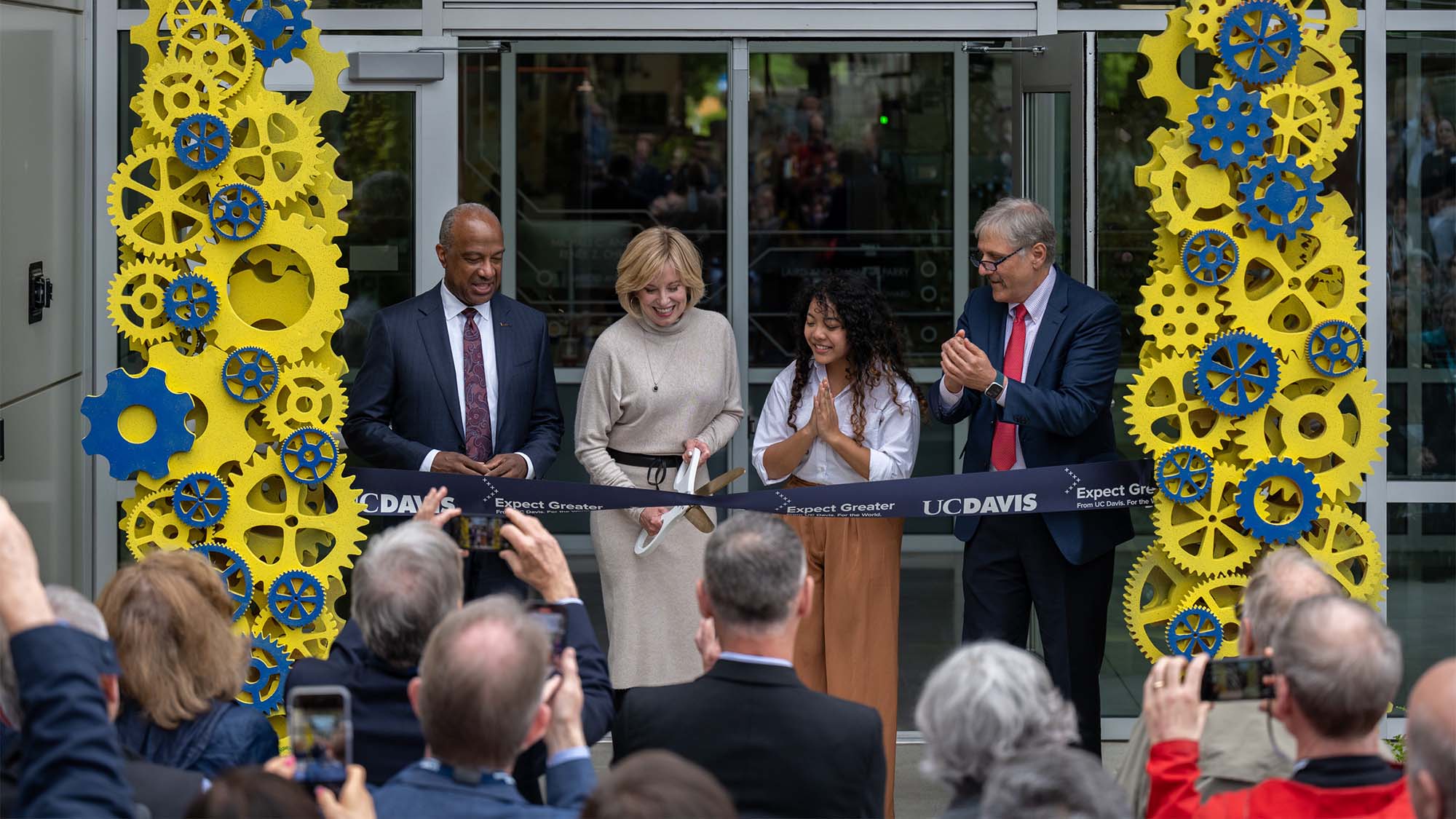 Four people cut ceremonial ribbon.