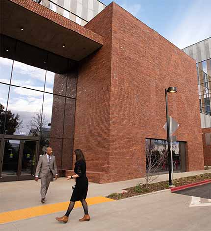 Aggie Square building spells out "Fiat Lux" in bricks