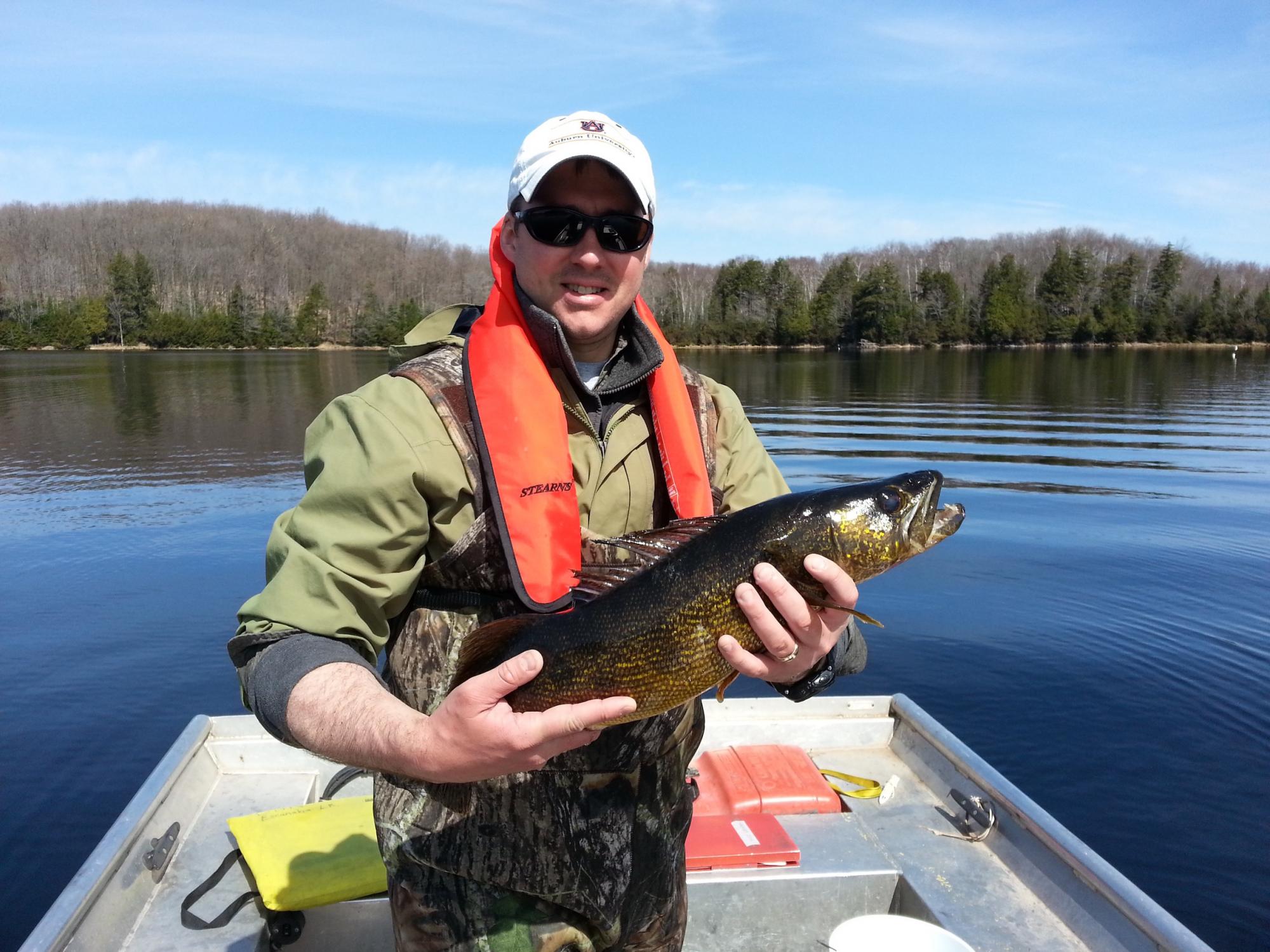 Scientist with walleye 