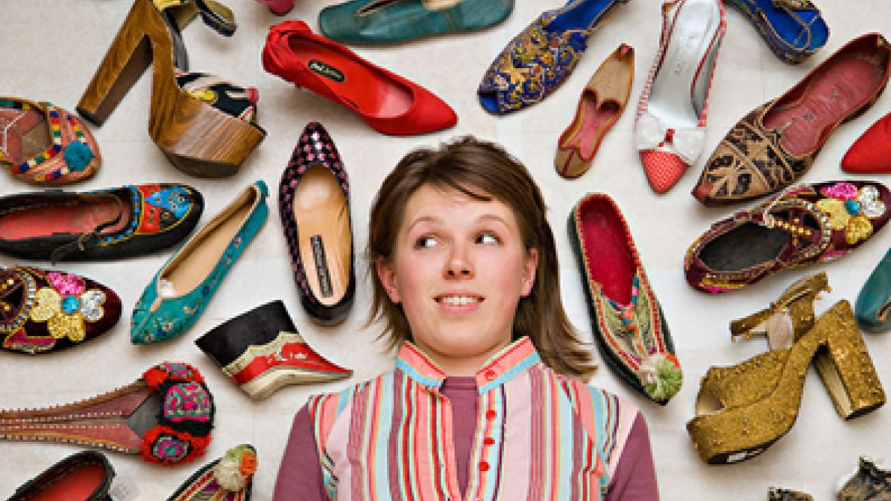 Student Nora Cary surrounded by footwear from around the world, as photographed by Karin Higgins