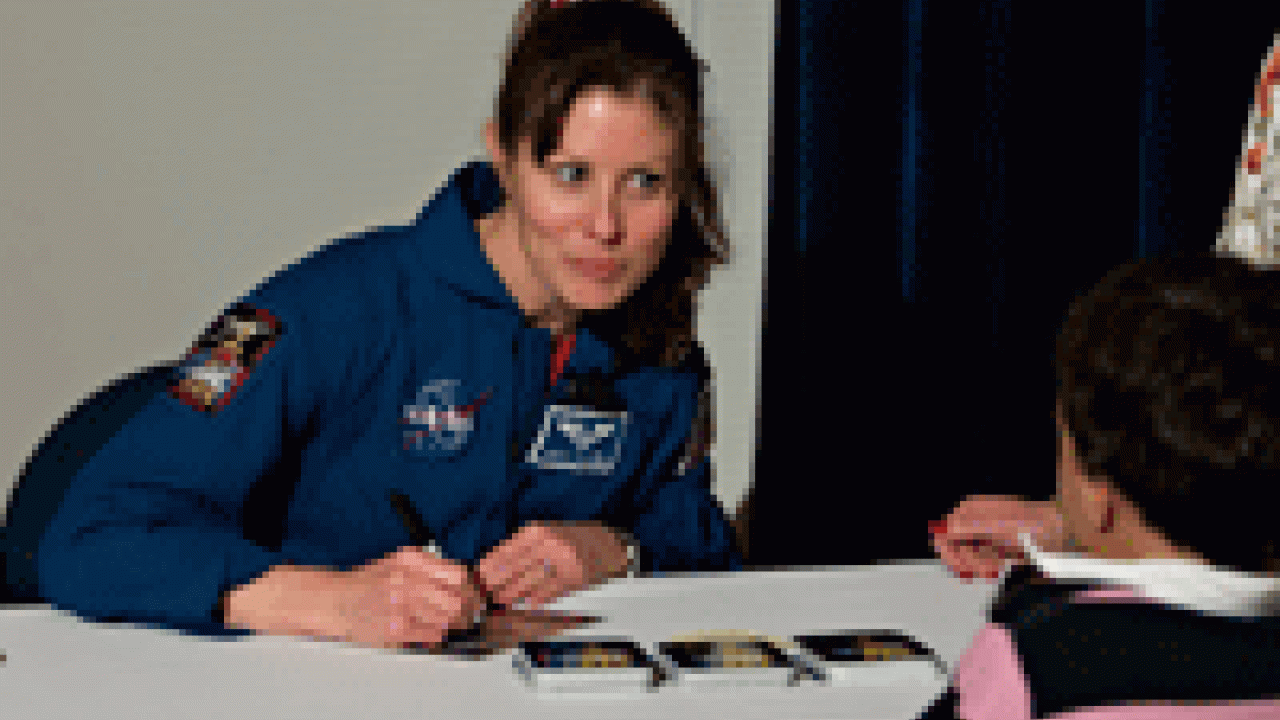 Tracy Caldwell, a NASA astronaut and UC Davis alumna, signs autographs after giving a Jan. 25 lecture on campus. 