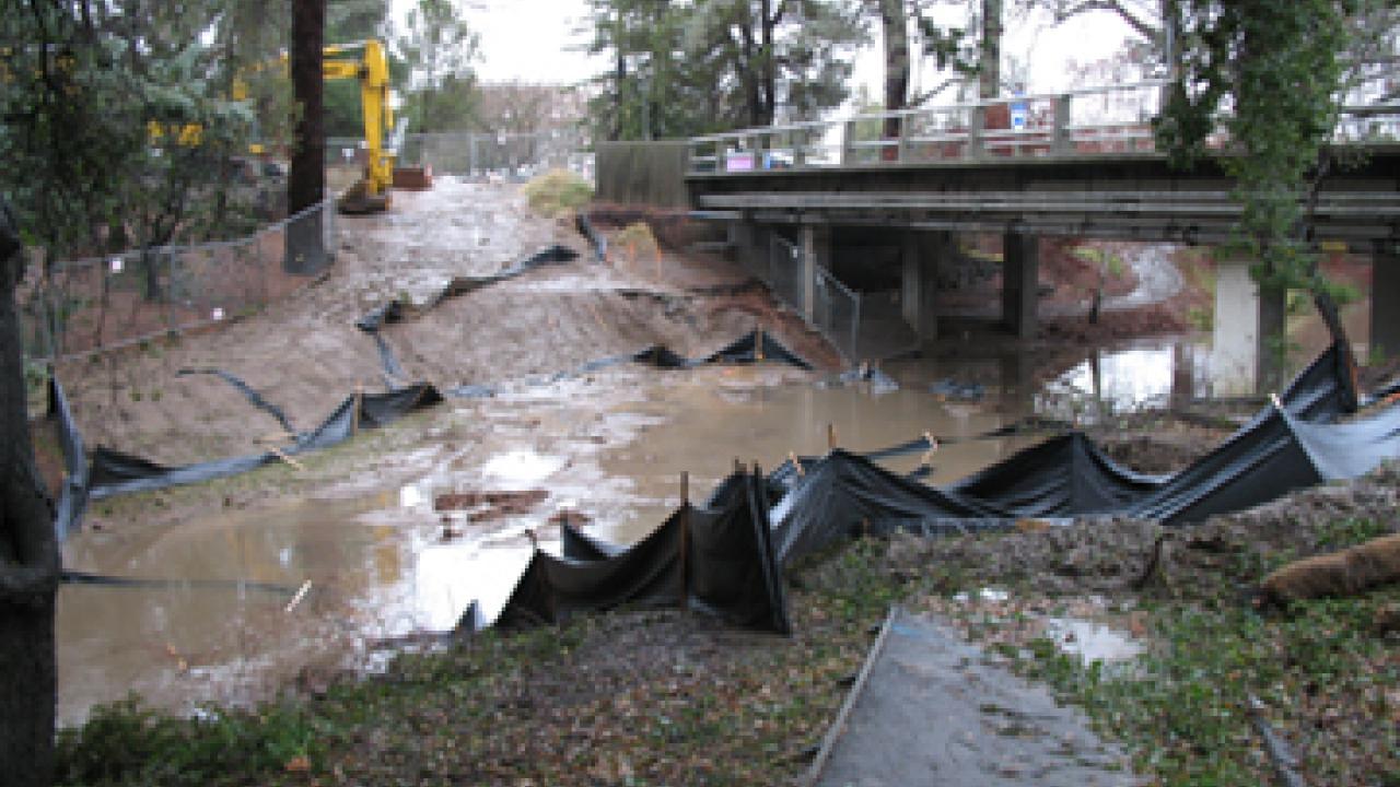 A temporary culvert and earthen dam are submerged in the arboretum waterway the afternoon of Jan. 4, just west of the California Avenue bridge.