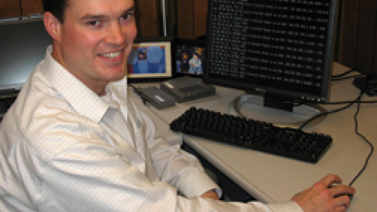 Greg Loge aims to ensure UC Davis computer networks are equipped with safeguards like firewalls, such as the one running on the monitor behind him.