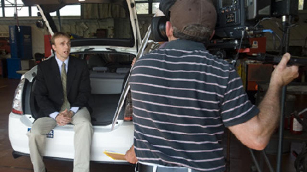 Professor Michael Kleeman sits in back of an alternative-fuel vehicle while being interviewed during a July 15 news conference.