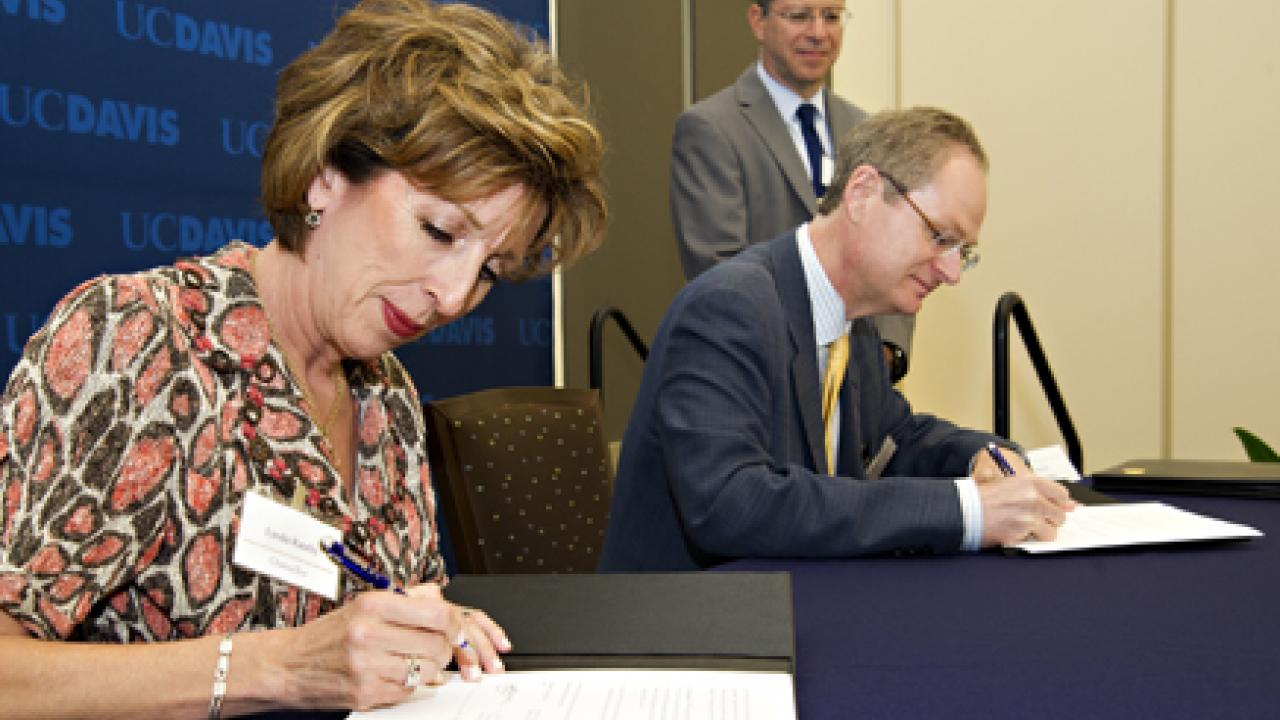 Photo: Chancellor Linda P.B. Katehi and LBNL Director Paul Alivisatos sign a memorandum of understanding for research collaboration.
