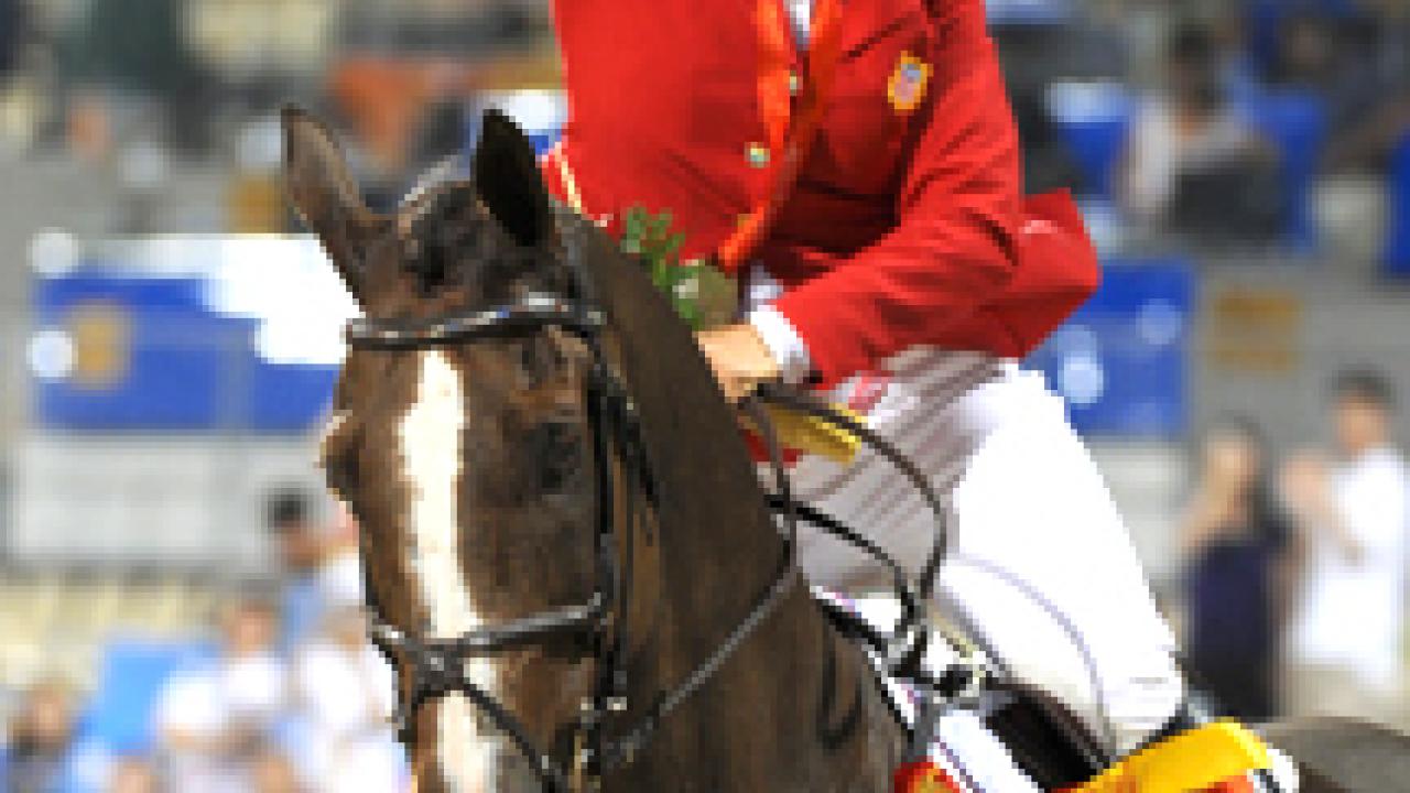 Gina Miles takes a victory lap aboard McKinlaigh after they win an Olympic silver medal in individual eventing in Hong Kong.