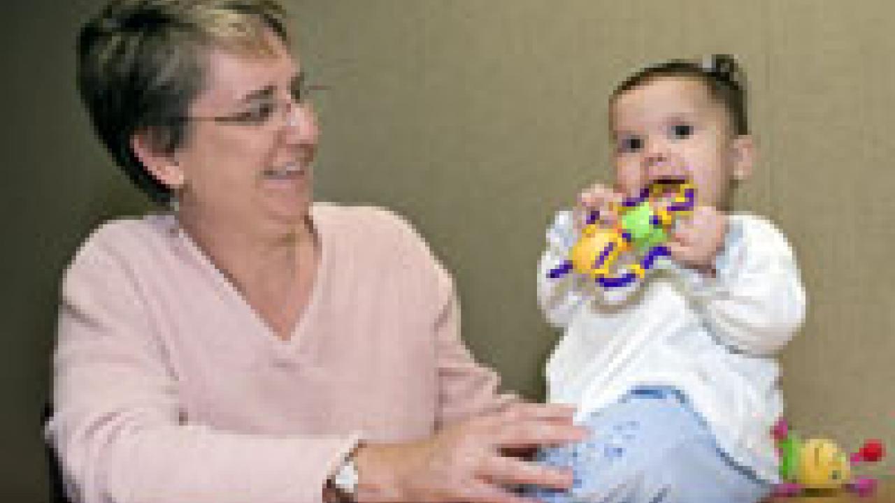 Psychologist Lisa Oakes plays with 7-month-old Sophia Sherman.