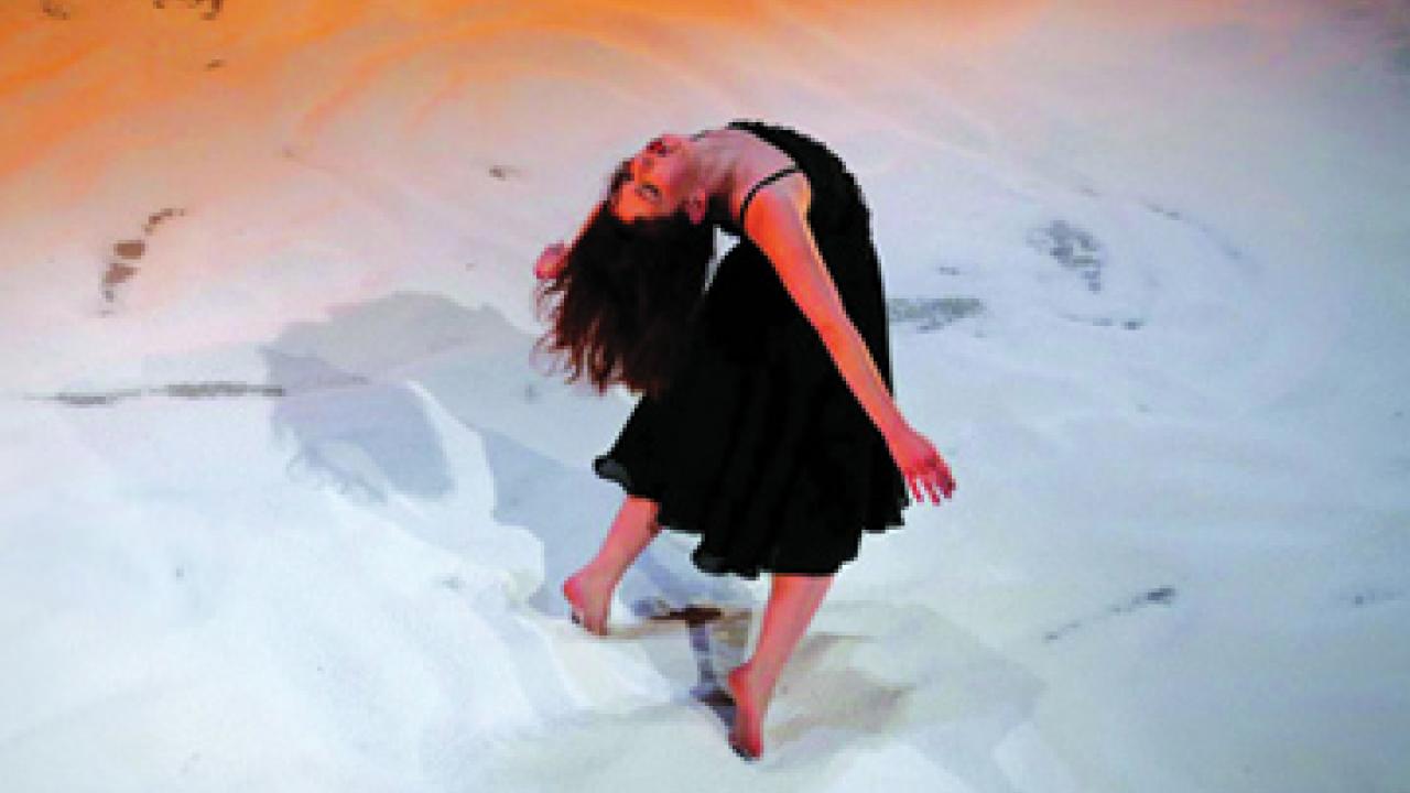 A dancer in Inbal Pinto's Shaker appears as if she were inside a snow globe.