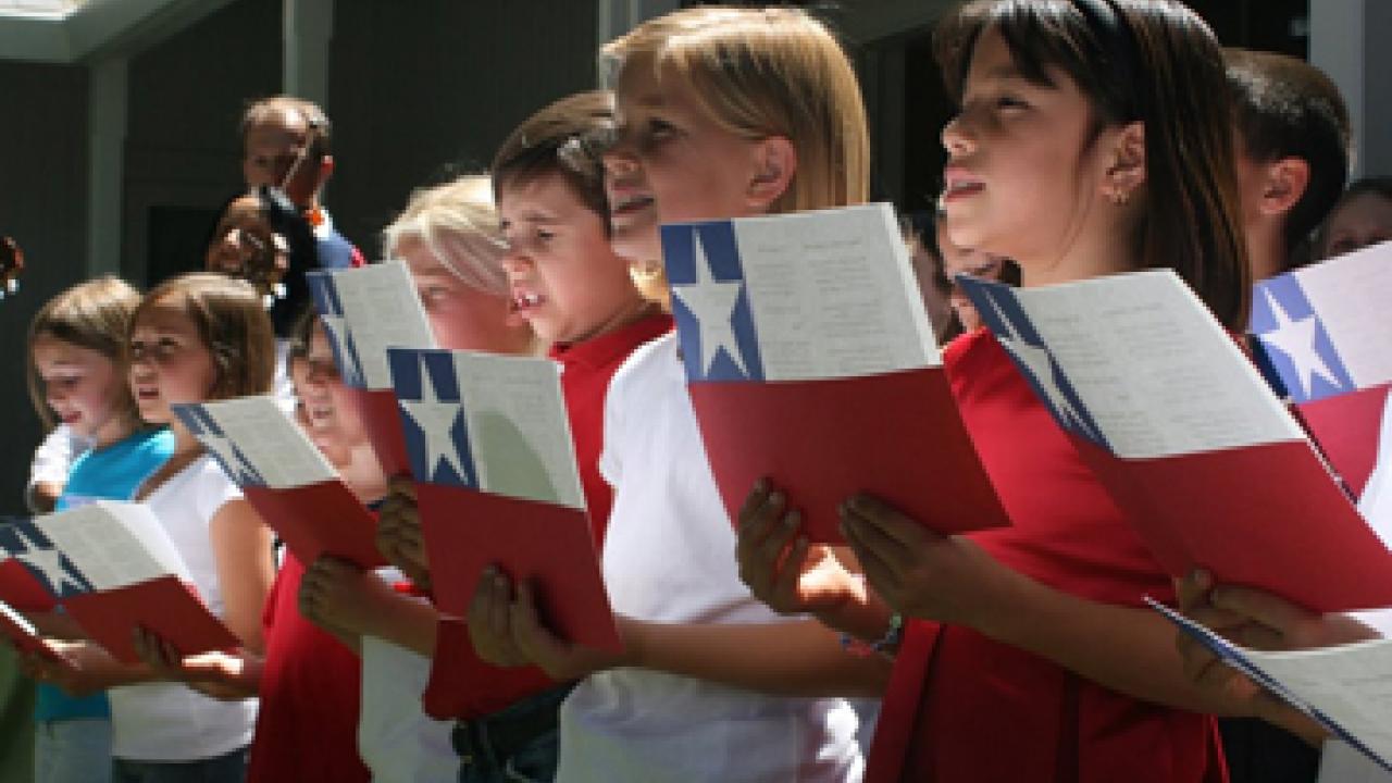 Third-graders from Cesar Chavez Elementary School sing for the president of Chile at Chancellor Larry Vanderhoef's residence on June 12.