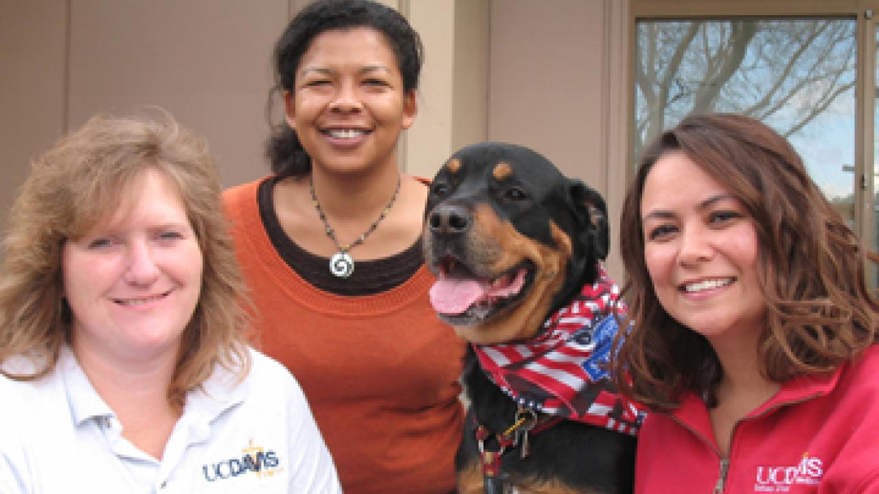 Regina Patton and her dog, Superstar, pictured with Dyne Hansing and Julie Burges outside the Veterinary Medical Teaching Hospital.