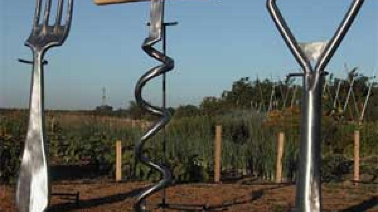 Photo: a giant-sized fork, corkscrew and bottle opener 
