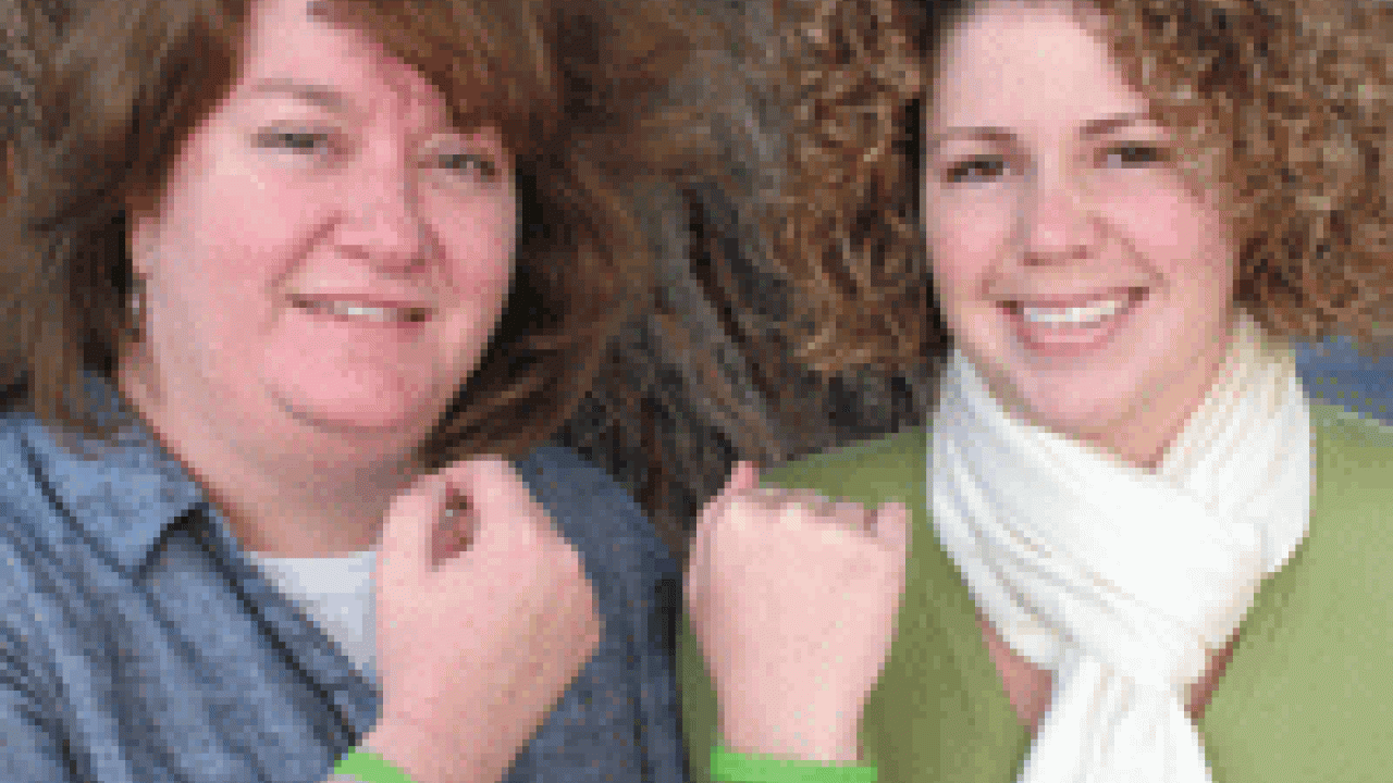 Paula Driver Shimada, left, and Brooklynn Mundy of the WorkLife unit show off the &lsquo;alien green&rsquo; wristbands that children will wear for Take Our Daughters and Sons to Work Day.