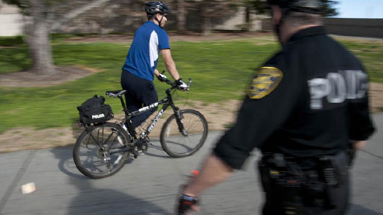 Photo: Campus police officer Ralph Nuno observes fellow officer Jason Barrera during a bicycle officer training class.