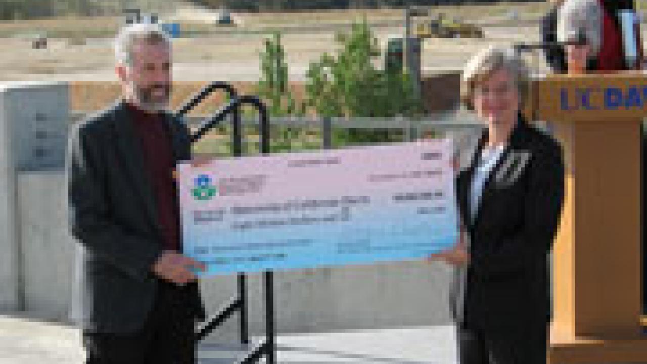 Engineering professor Tony Wexler, left, receives a big check from Deborah Jordan of the U.S. Environmental Protection Agency.