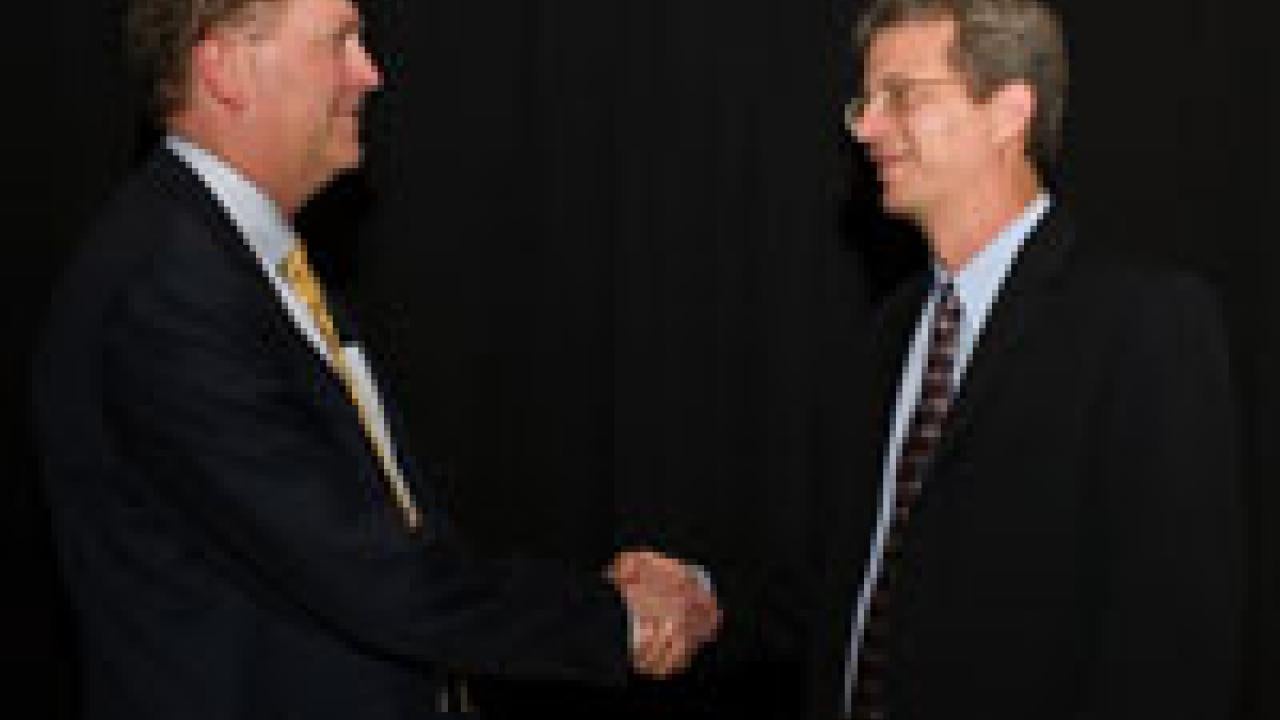 Professor Robert Feenstra, right, holds the Bryan Cameron Distinguished Chair in International Economic. Cameron is on the left.