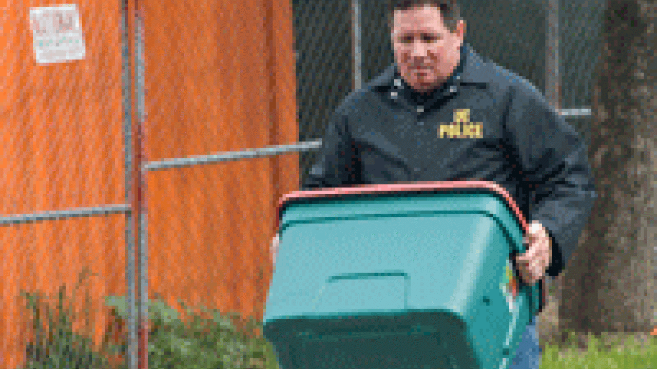 Sgt. Paul Henoch of the UC Davis Police Department carries a container out of the student dorm room where explosive materials were found March 6.