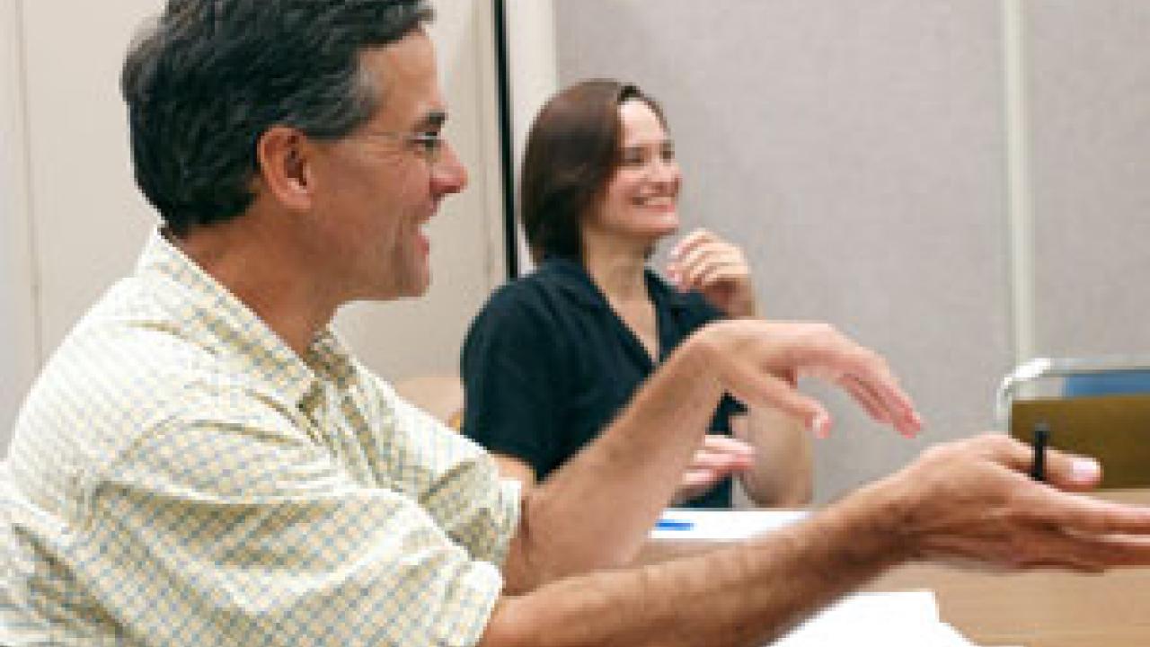 Dave Smart, left, a professor of viticulture and enology, and Victoria Cross, a program coordinator with the Teaching Resources Center, talk about better teaching strategies and techniques with other faculty members during a Lecture Club group d