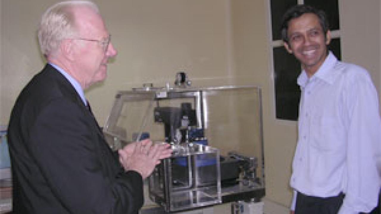 Chancellor Vanderhoef enjoys an exchange with an Indian Institute of Science researcher in Bangalore, India, who toured the UC Davis delegation through the institute's nanotechnology facility, outfitted with the latest in scientific equipment.