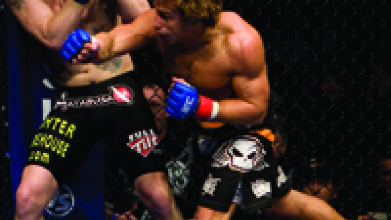 Urijah Faber throws a punch in his January 2009 first-round victory against mixed martial arts pioneer Jens Pulver in San Diego. Faber, a former Aggie wrestler, is seeking to regain his World Extreme Cagefighting featherweight title.