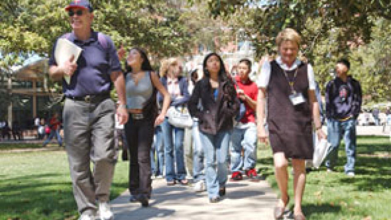 Alex Russell of Undergraduate Admissions and Outreach Services, right, leads Head Counselor John Maiers, left, and about 30 juniors and seniors from Alameda High School to their next stop during a campus visit this month. &ldquo;As a counselor,&rdquo; s