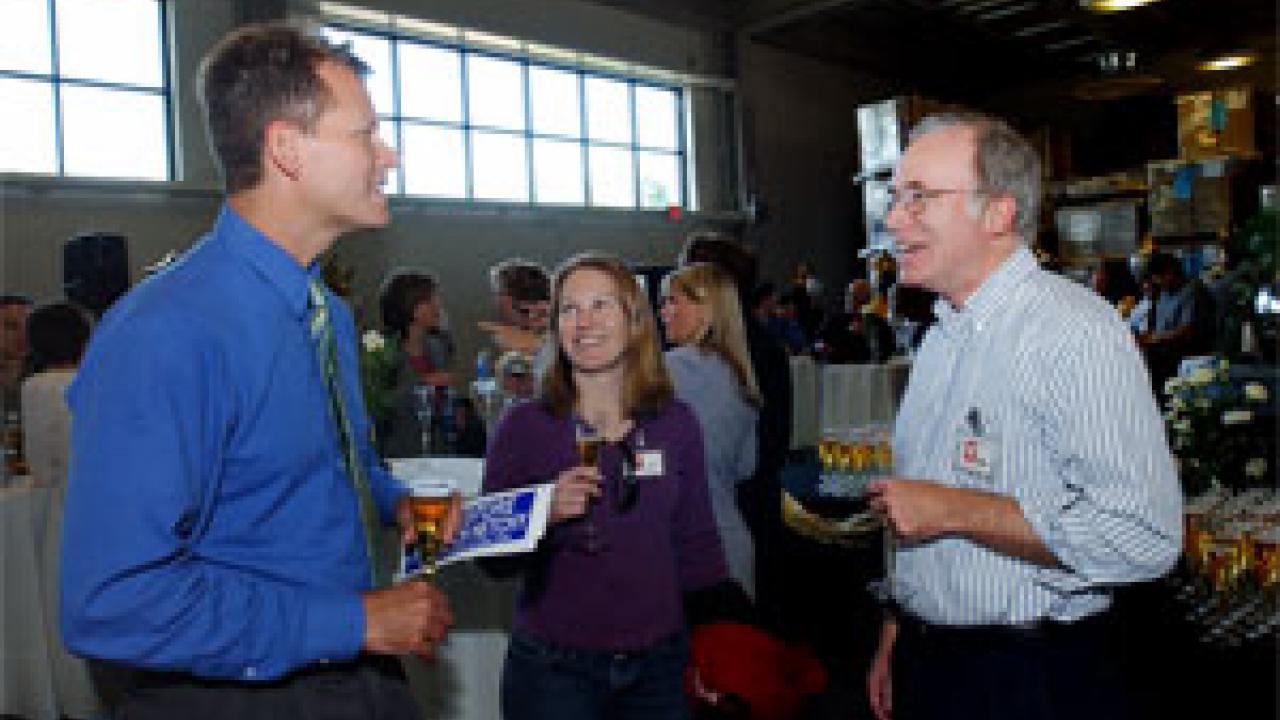 Tom Philp, left, of The Sacramento Bee talks with UC Davis graduate student Sarah Null and faculty adviser Jay Lund, a professor in civil and environmental engineering, during a reception at the Bee honoring Philp for winning  the 2005 Pulitzer 