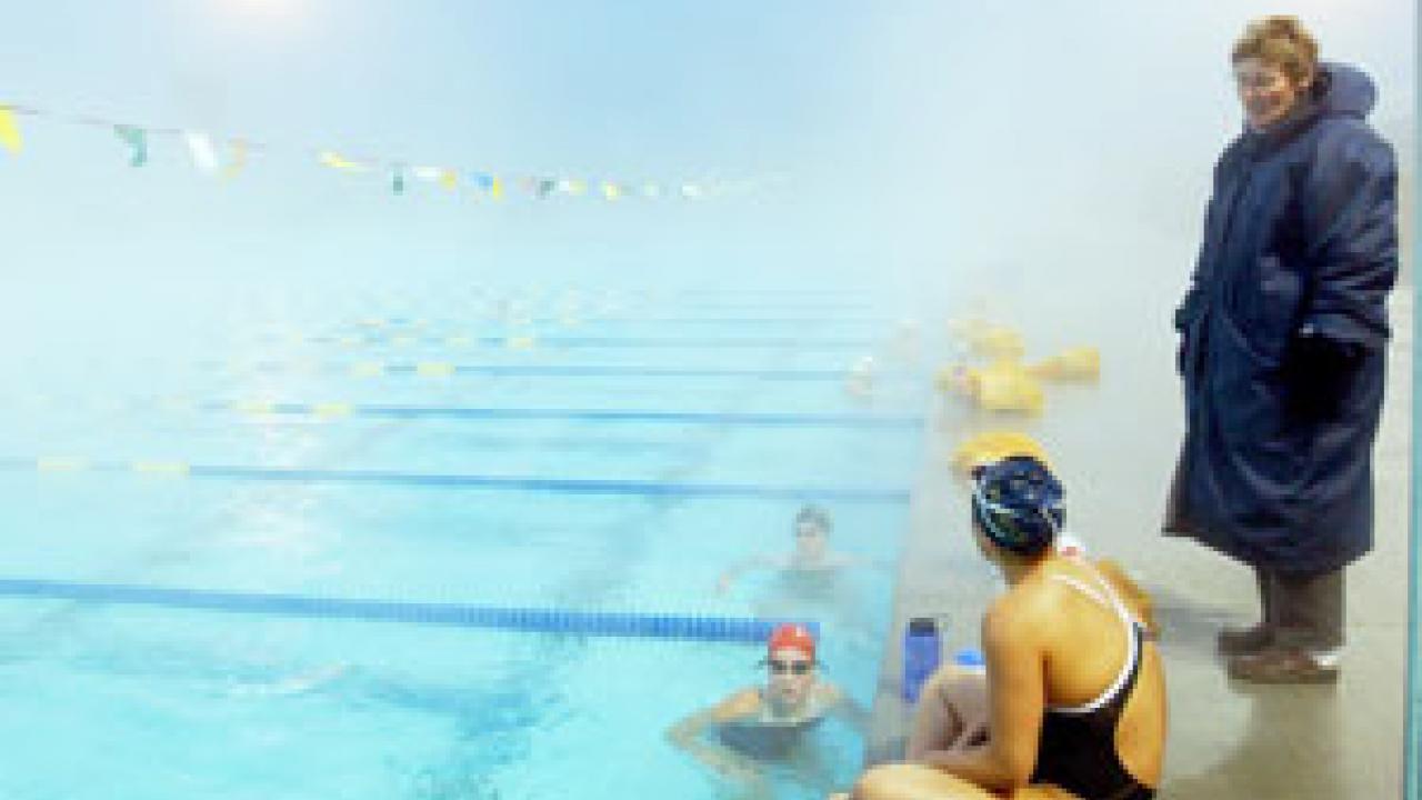 Barbara Jahn, head coach of UC Davis women&rsquo;s swimming, conducts practice during a foggy January morning at the aquatic center &mdash; the new home of all six of the campus&rsquo;s intercollegiate aquatic sports teams. 