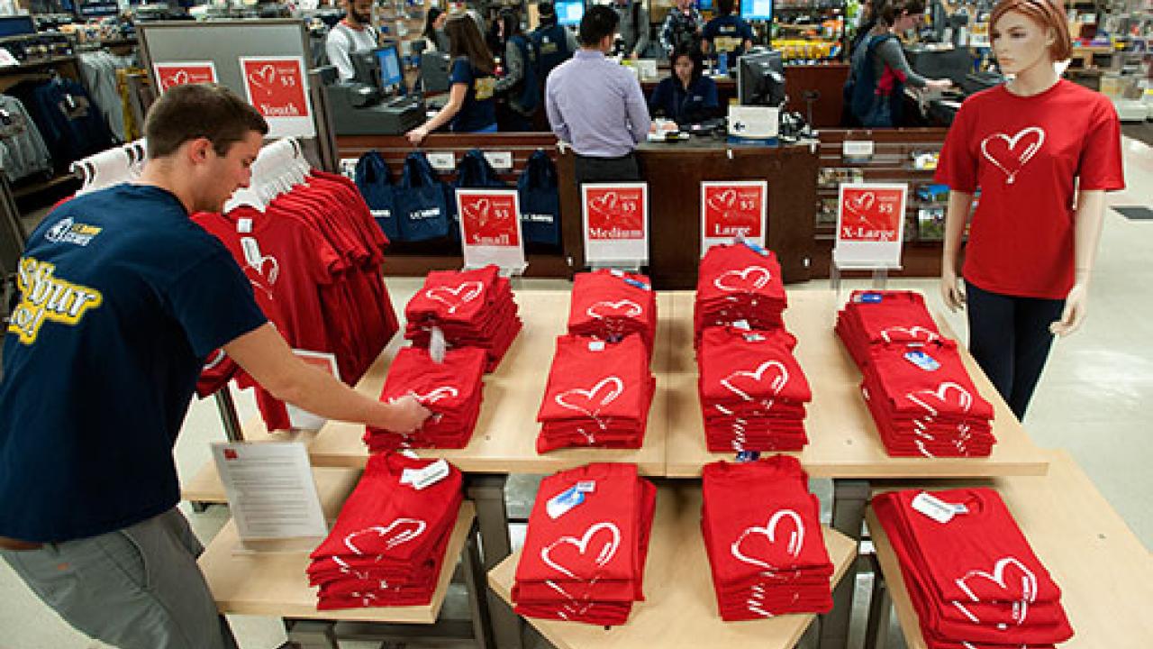 Photo: UC Davis Stores employee Oliver Mikkelson, a viticulture major, straightens display of heart T-shirts in the main bookstore.