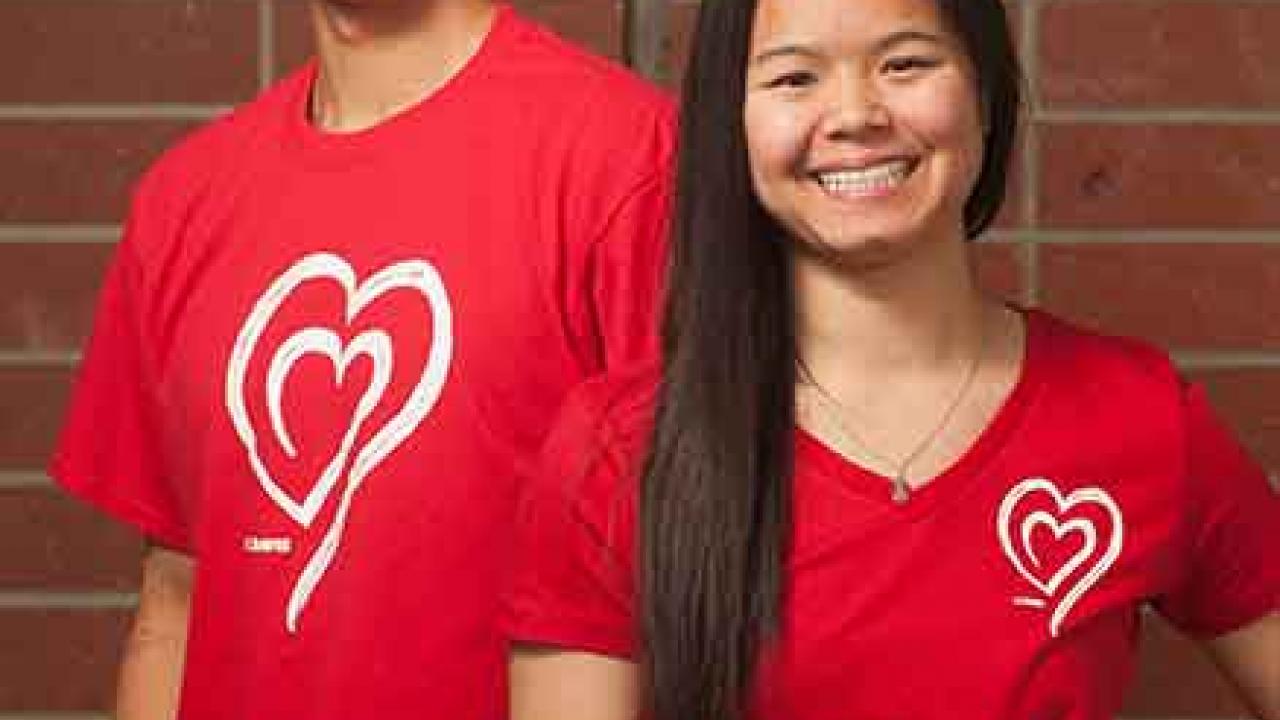 Photo: Two students model UC Davis Wears Red Day T-shirts.