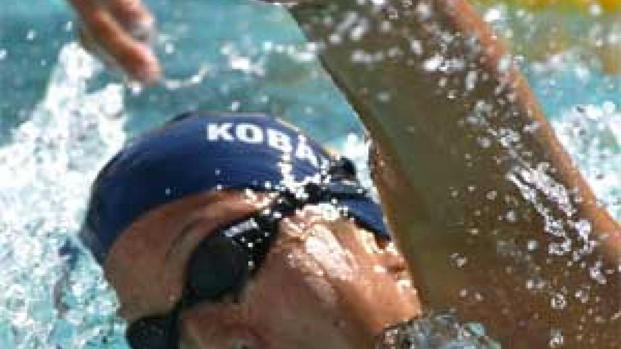 Photo: woman swimming in cap and goggles