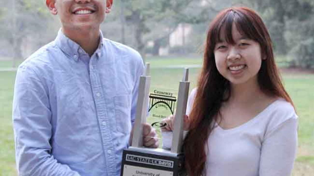 Photo: Two students hold the Causeway Classic Blood Drive perpetual trophy.
