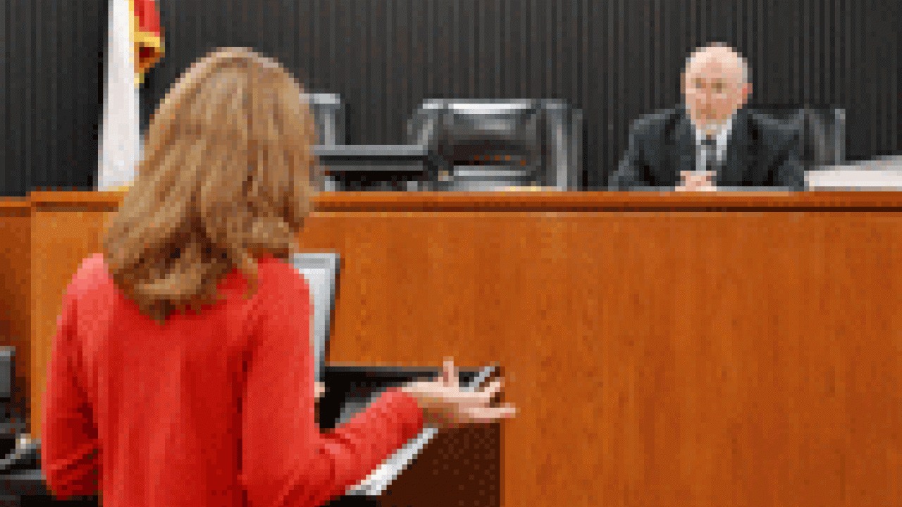 Photo of a law program student arguing a case before a judge in a mock courtroom at UC Davis