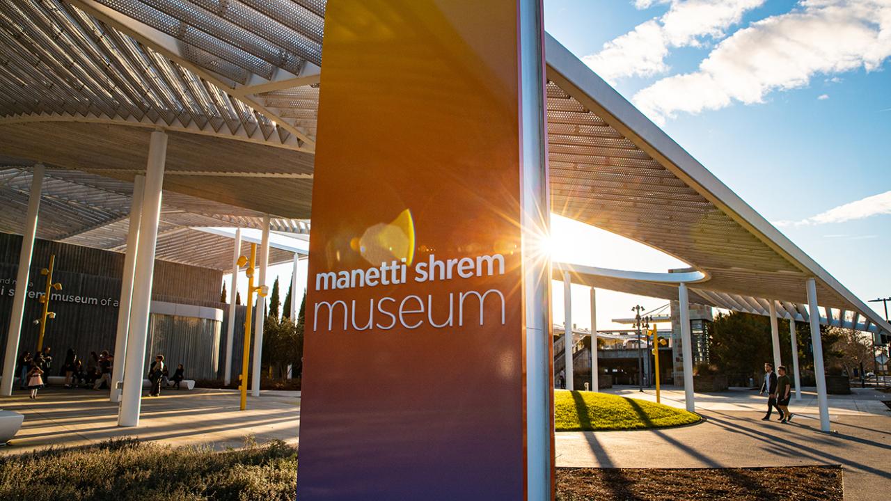 Photo of Manetti Shrem Museum in winter sunshine, showing orange and purple hues