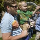 Cosumnes River College Professor James Frazee holds his 2-year-old son, Caleb, as they chase bubbles at the Multicultural Childrens Faire in the courtyard of Hart Hall.
