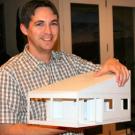 Aspiring architect Aaron Pyle shows off a scale model that he is building for a house that he designed.