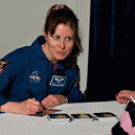 Tracy Caldwell, a NASA astronaut and UC Davis alumna, signs autographs after giving a Jan. 25 lecture on campus. 