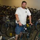 Scott Hutchison, Bicycle Program assistant, shows off some of the more than 350 bicycles that are due to go up for auction May 3.