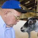 Photo: man talking to goat