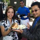 Staff Assembly&rsquo;s Alyssa Varela and Peter Blando display a meal much like those to be served at the 2008 TGFS Picnic on May 7: A Buckhorn Steak & Roadhouse tri-tip sandwich and Granny Smith apple coleslaw. The Buckhorn&rsquo;s Silverio Arteaga did 