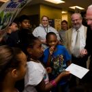 Eight-year-old Anaiya Wilson accepts Chancellor Larry Vanderhoef's $5,000 donation to the Boys & Girls Clubs.