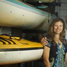 Photo: Sharon Coulson and Ted Abresch, husband and wife, in front of ocean kayaks at Outdoor Adventures