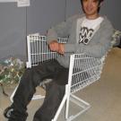 Third-year design student Tao Pang sits in the shopping cart that he turned into a chair.