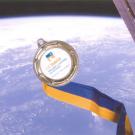 Photo: A College of Letters and Science commemorative medal is floating in space, inside the cupola observatory, on the International Space Station.