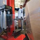At Bulk Mail Services, senior mail processor Pravin Sharma uses a new machine that automatically wraps a pallet full of bulk mail; the pallets can then be moved easily by pallet jack. Previously, employees moved bulk mail in carts that weighed 7